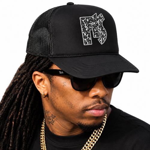 F1S Bape black trucker hat worn by model against white background
