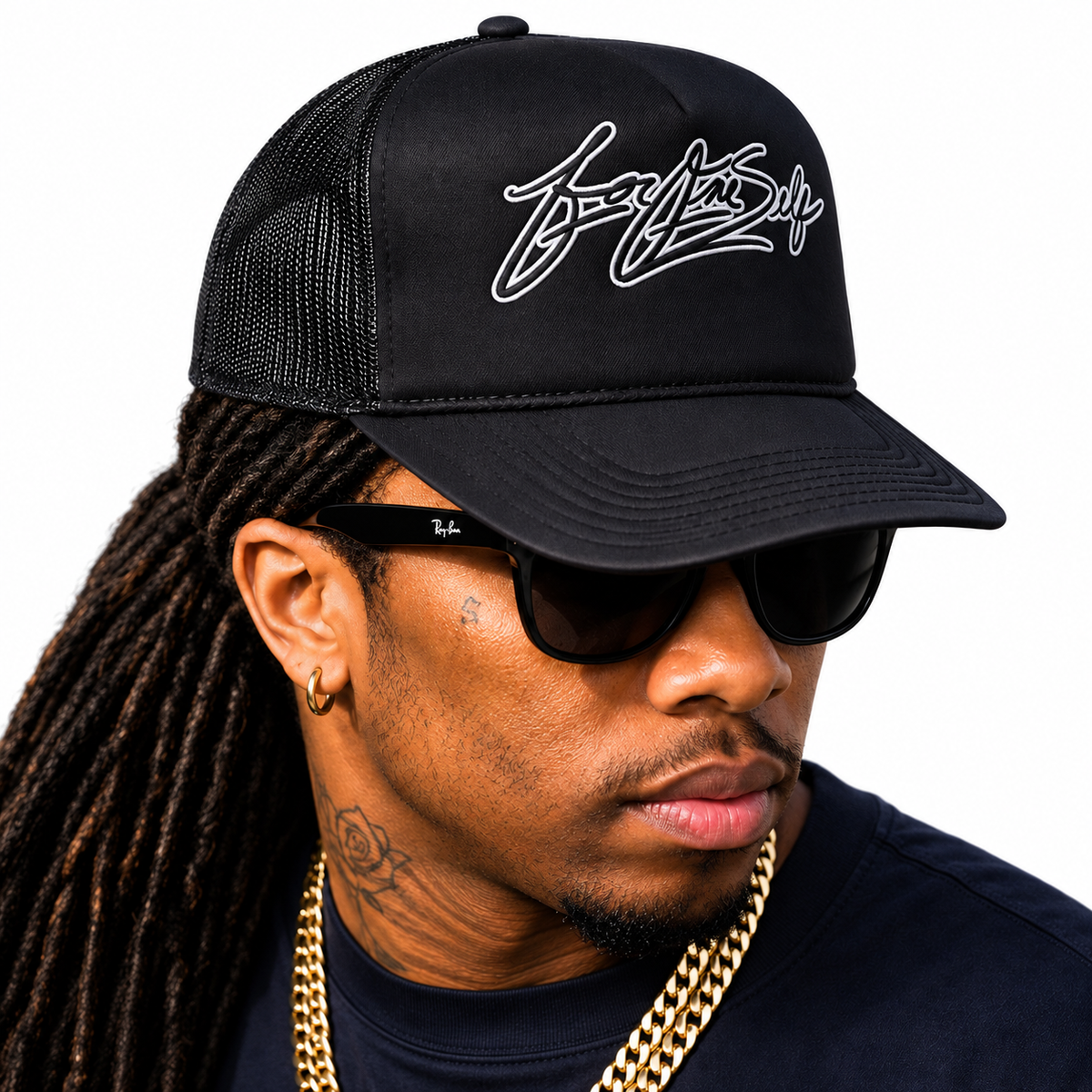 ForOneSelf black foam trucker hat worn by model against white background